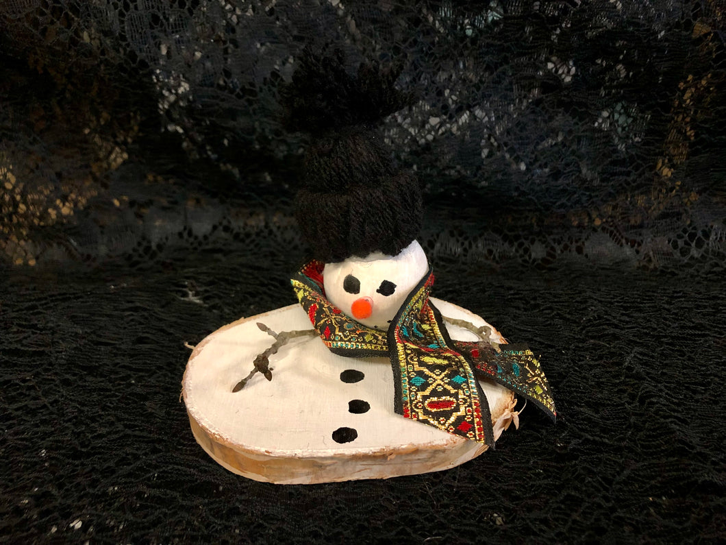 Melted Snowman with Black Hat and Large Black, Red, Green, and Gold Scarf